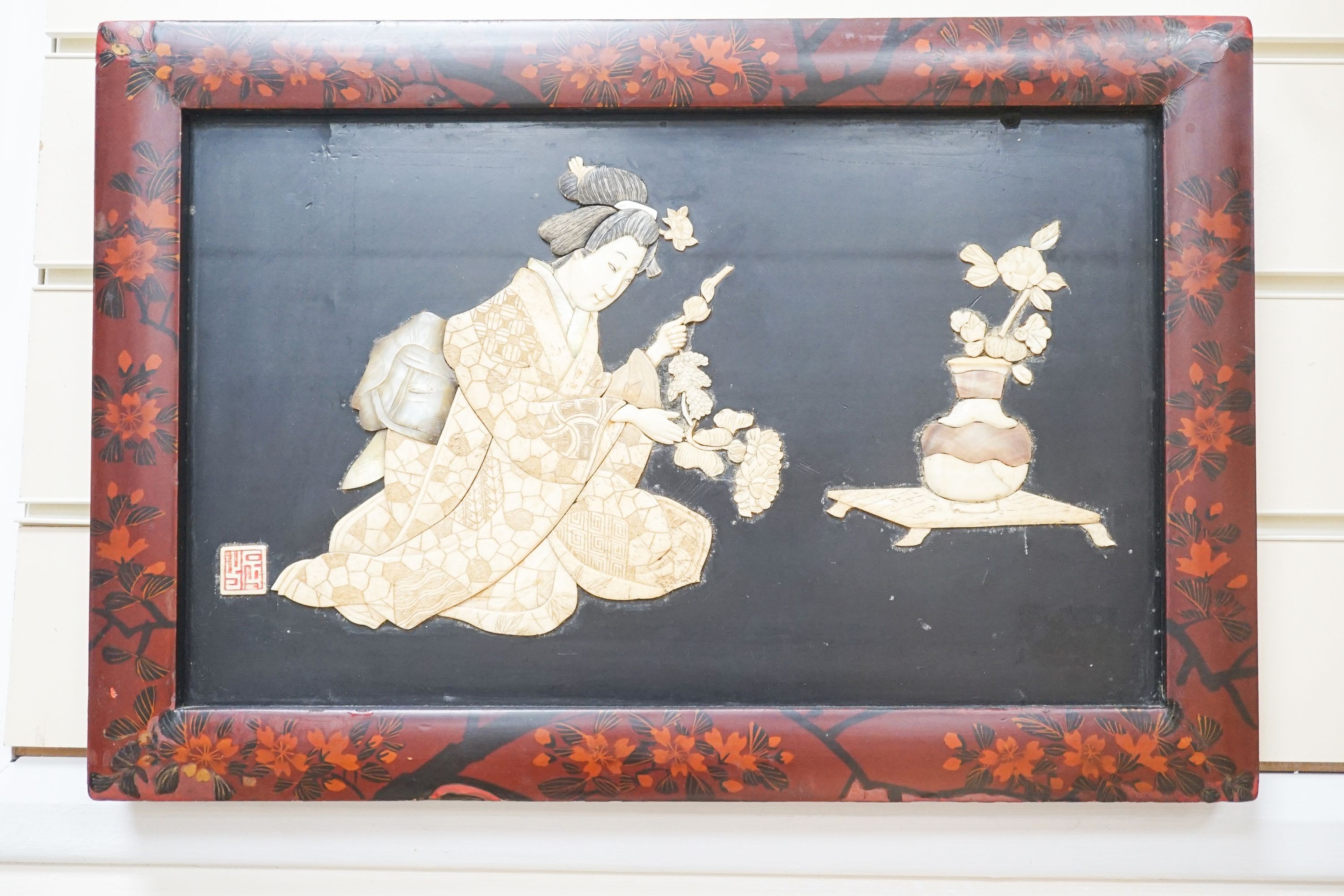 A pair of Japanese Shibayama style ivory, bone and mother of pearl inlaid lacquer panels, Meiji period, depicting two seated men, the other a bijin, 30 x 45cm